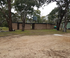 Open camping area with caravans and trees
